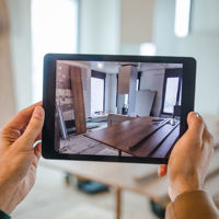 Adjuster Taking Photos Of Interior On Tablet 