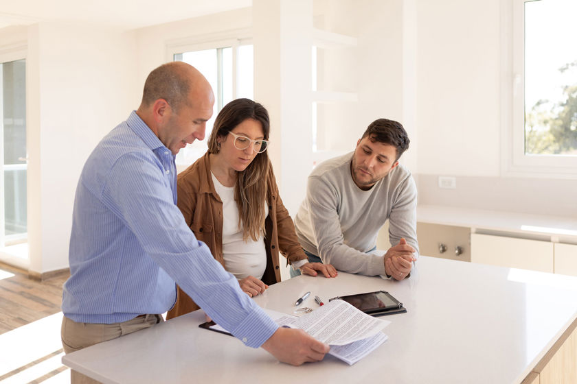 Homeowners Discussing Repairs With Adjuster 
