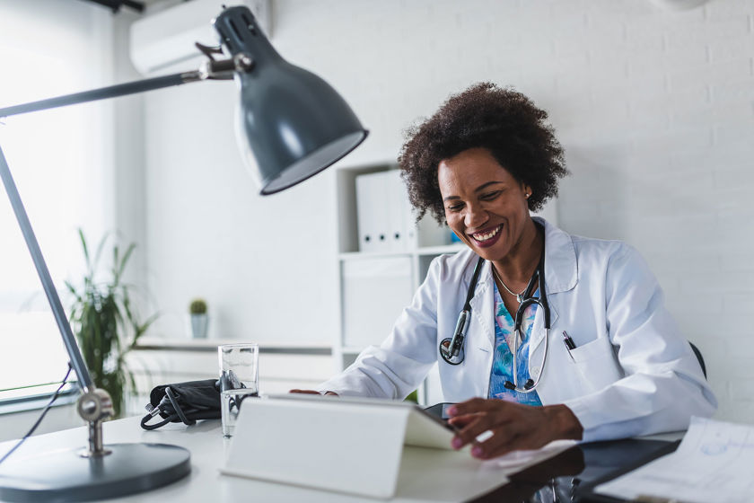 Medical Professional At Work On Tablet 