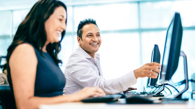 Happy Colleagues Collaborating At Desktop Screens 2 