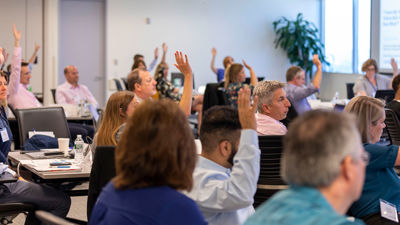 Verisk Employees Raising Hands 