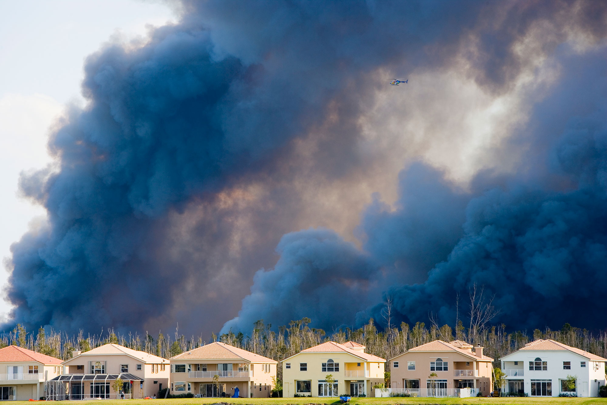Wildfire Plumes Above Row Of Homes 