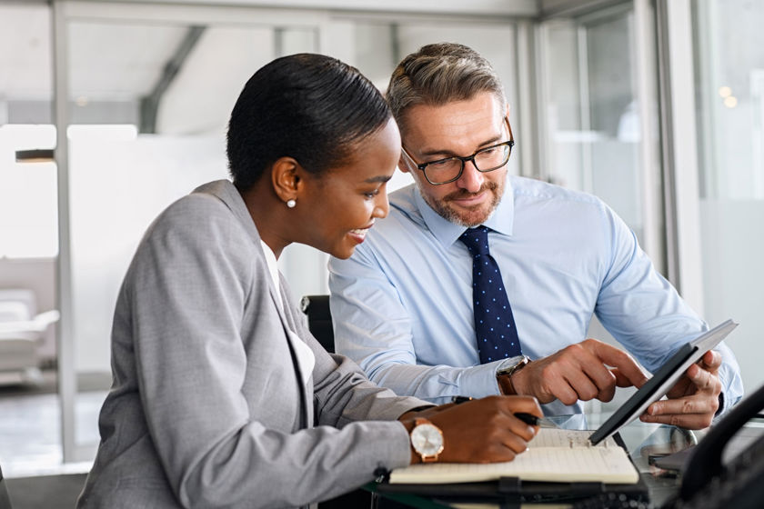 Colleagues Discussing A Solution On A Tablet 