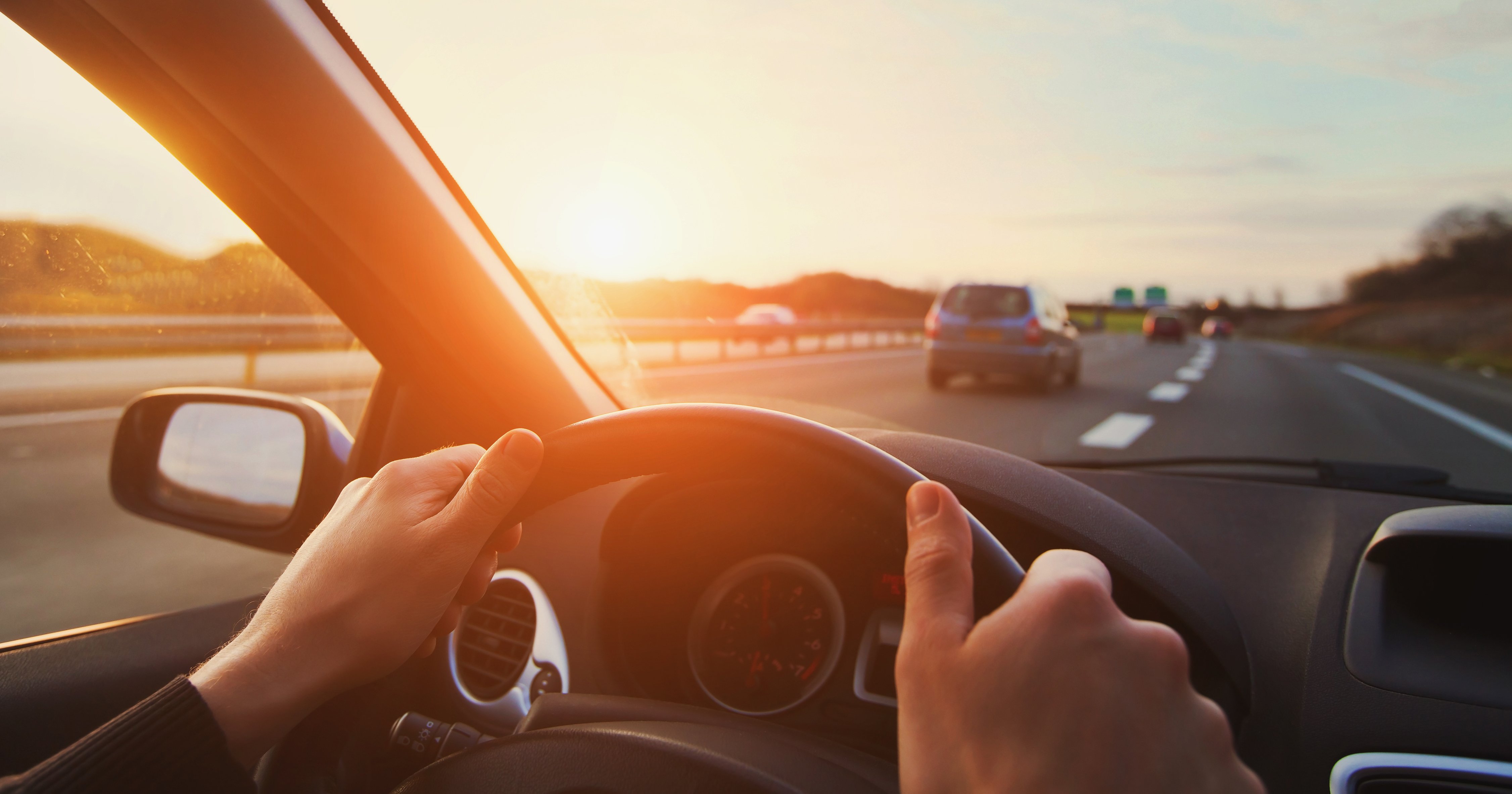 Hands on Steering Wheel of Car