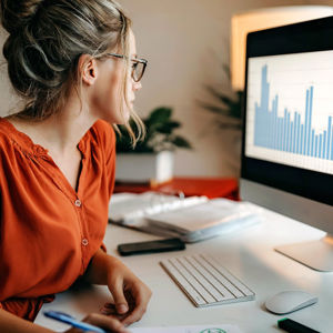 Woman Reviewing Data On Computer Screen 