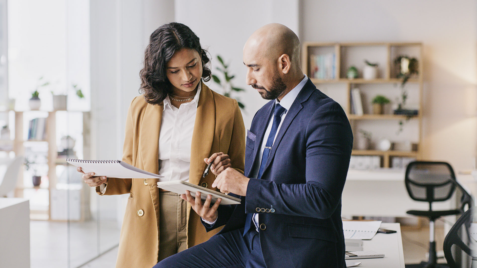 Coworkers Reviewing Data On Tablet Computer 
