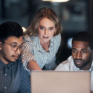 Group Of Coworkers Reviewing Laptop Screen 