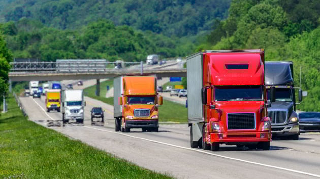 Many Semi Trucks Traveling Down Highway 