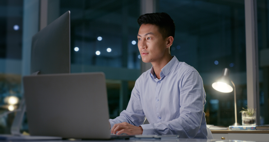 person-looking-at-computer-screens-in-an-office
