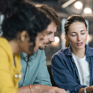 Coworkers Reviewing Data On Laptop 