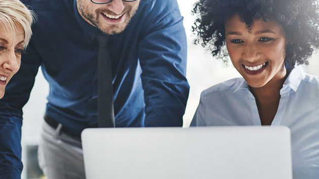 Colleagues Collaborating On Laptop 