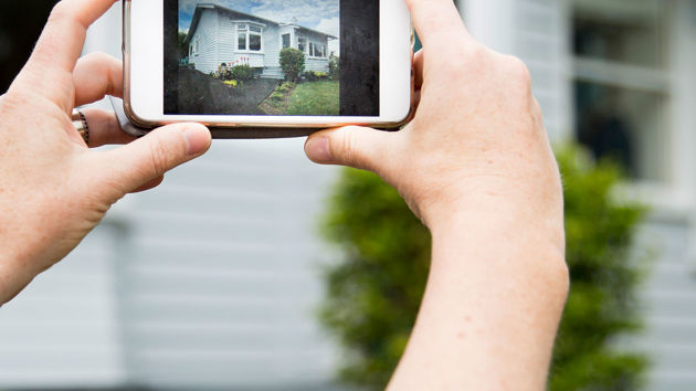 Taking Photo Of Home Exterior On Mobile Phone 