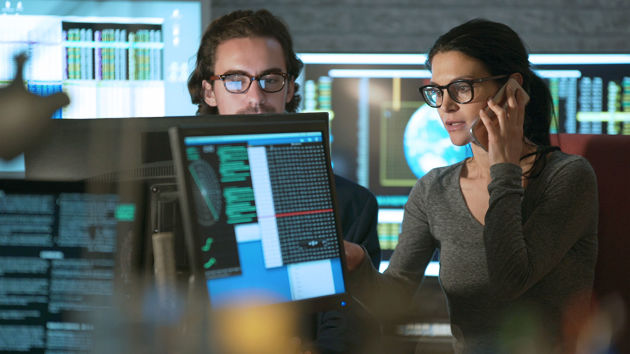 Two Serious Individuals Working With Screens 