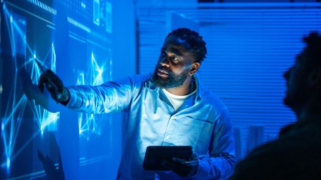 Man Working On Interactive Digital Wall 
