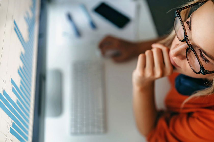 Woman Reviewing Data On Screen 