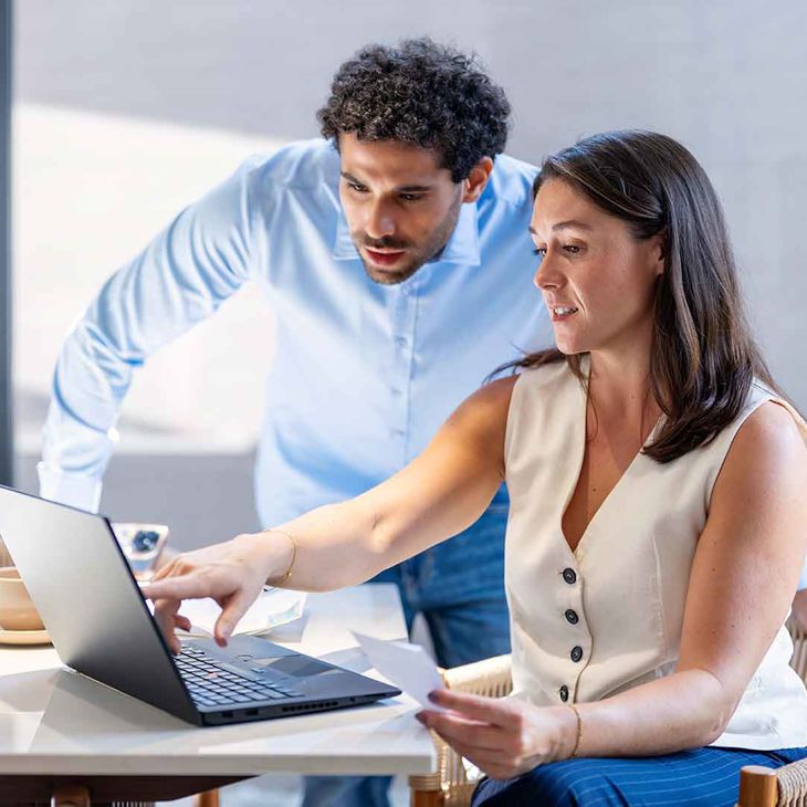 Man And Woman Reviewing Laptop Screen In An Office 