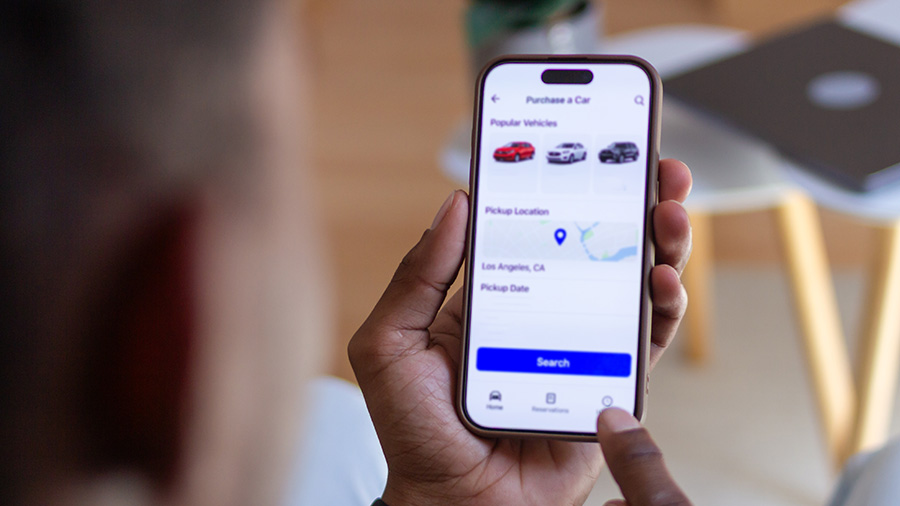 Person Holding Phone With Car Data 