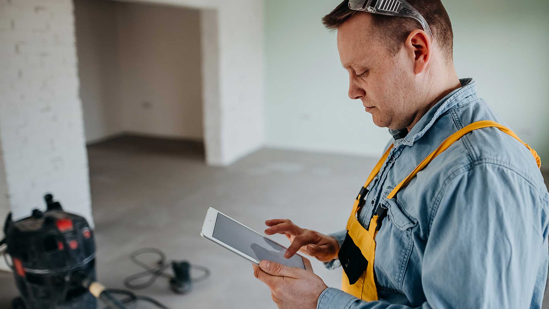 Contractor Using Tablet On Job Site 