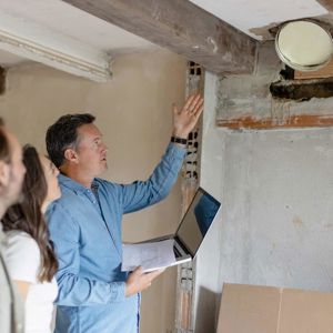 Contractor Discussing Restoration With Homeowners 