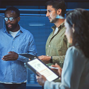 Group Of Coworkers Revewing Data On Screens 