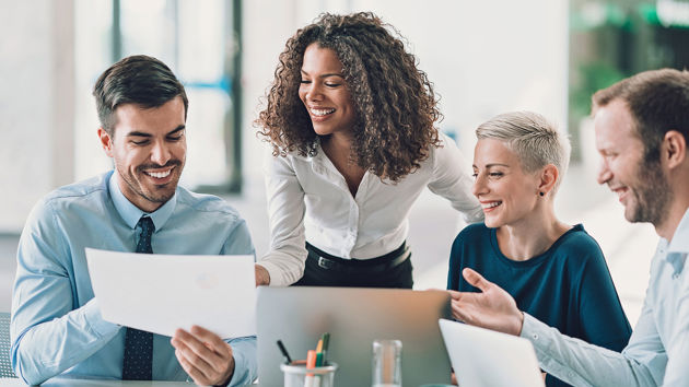 Pleased Colleagues Reviewing A Document 