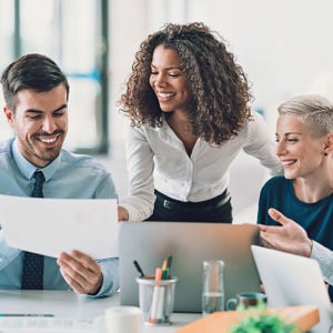Pleased Colleagues Reviewing A Document 